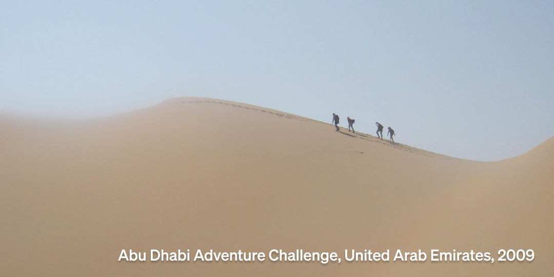 DART adventure racing team cresting a dune in the desert