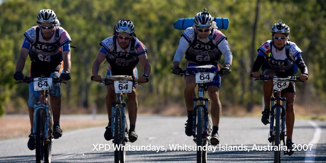 Image of the DART adventure racing team on their bikes competing in an event